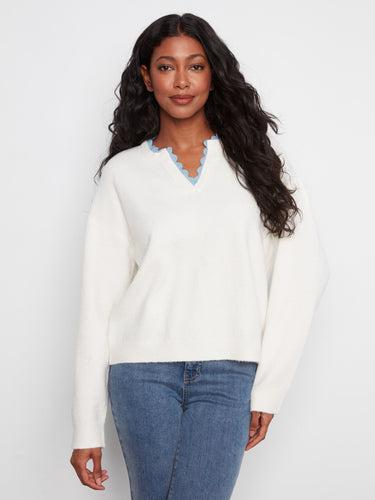 Sweater featuring a V-notch neckline with woven trim adds a unique touch, perfect for casual outings. By Charlie B.