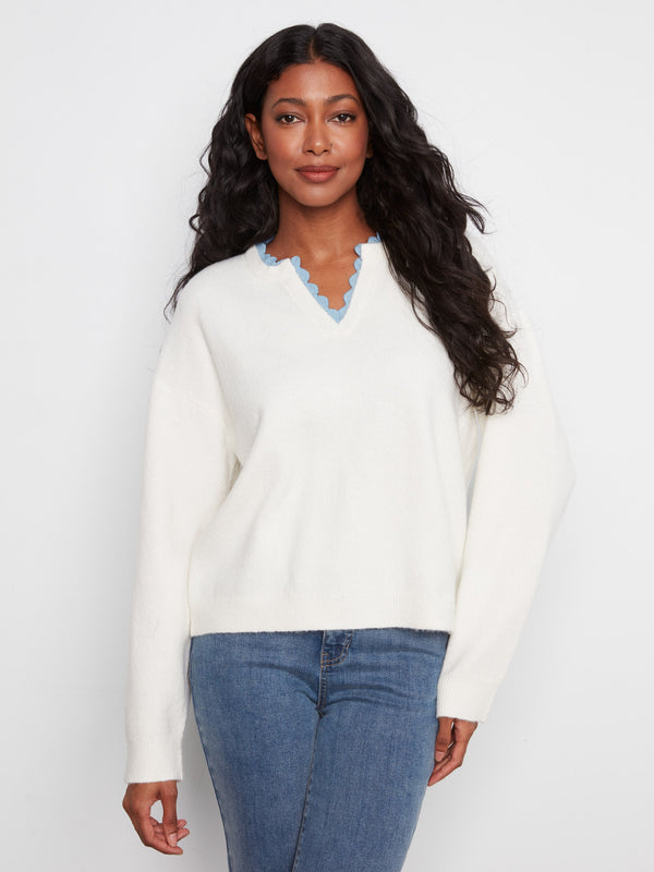 Sweater featuring a V-notch neckline with woven trim adds a unique touch, perfect for casual outings. By Charlie B.