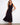 The dress features a sophisticated V-neckline that enhances its elegant appeal by Charlie B.