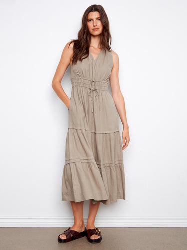 Chic sleeveless dress with practical slash pockets for added functionality and style. By Charlie B.