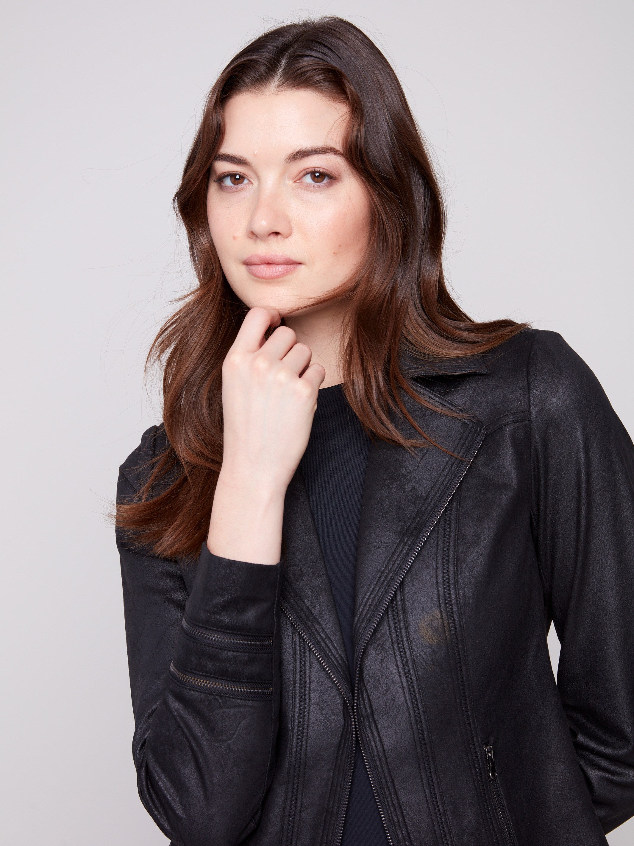 Fashionable faux leather jacket designed with practical faux pockets and zipper details by Charlie B.