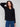 Elegant black sweater with wide cuffs featuring button accents, perfect for a stylish look by Charlie B.