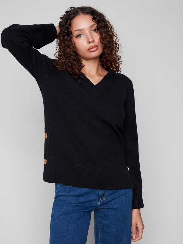 Elegant black sweater with wide cuffs featuring button accents, perfect for a stylish look by Charlie B.