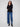 Chic black sweater showcasing buttons at sleeves and sides, ideal for versatile styling by Charlie B.