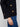 Stylish black sweater with eye-catching buttons on the sleeves, enhancing its modern appeal by Charlie B.