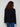Classic black V-neck sweater highlighting wide cuffs and sleek design elements by Charlie B.