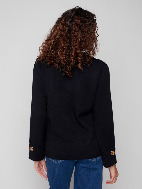 Classic black V-neck sweater highlighting wide cuffs and sleek design elements by Charlie B.