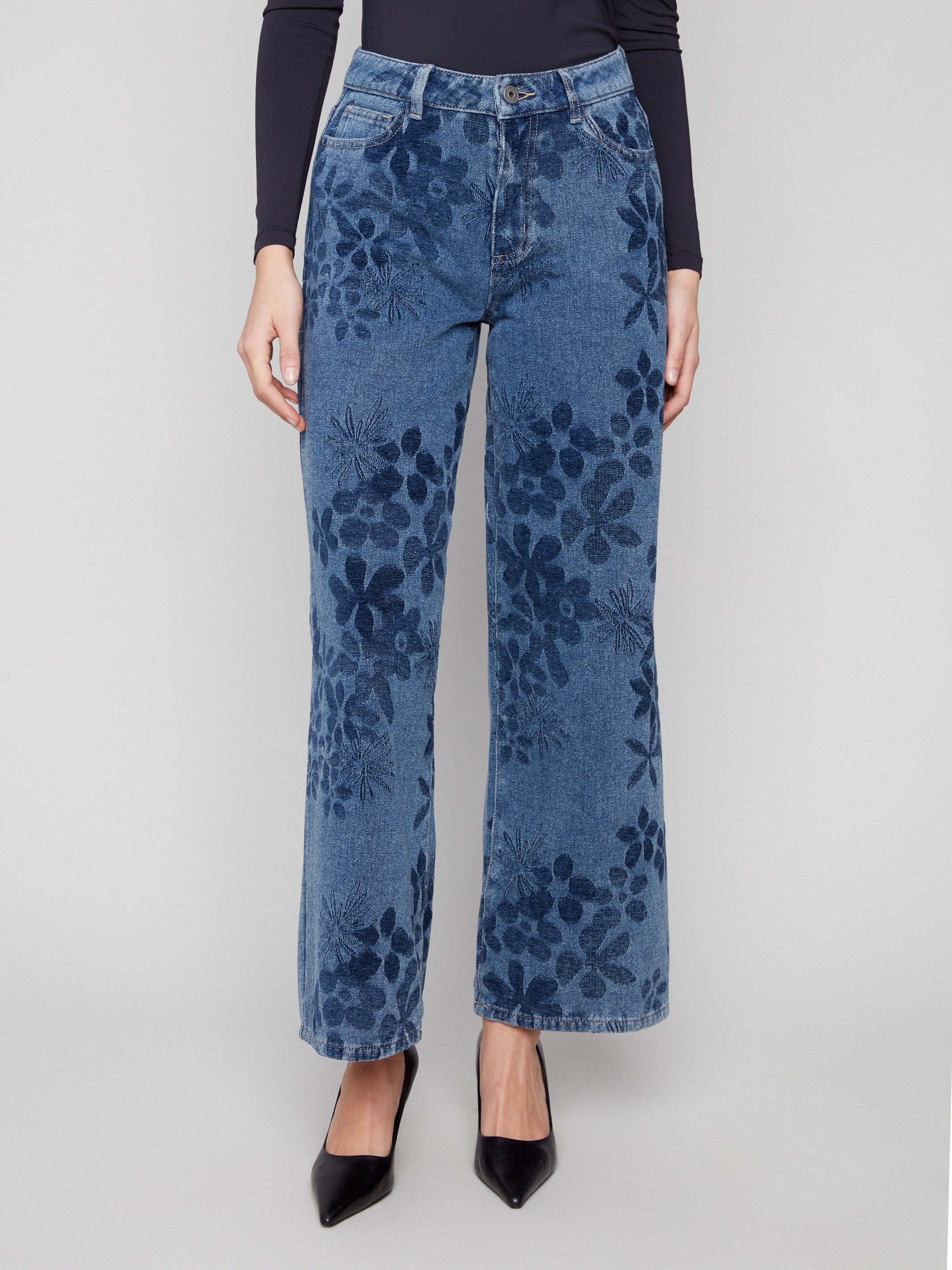 These jeans showcase a long length with an intricate floral jacquard design, perfect for versatile styling by Charlie B.