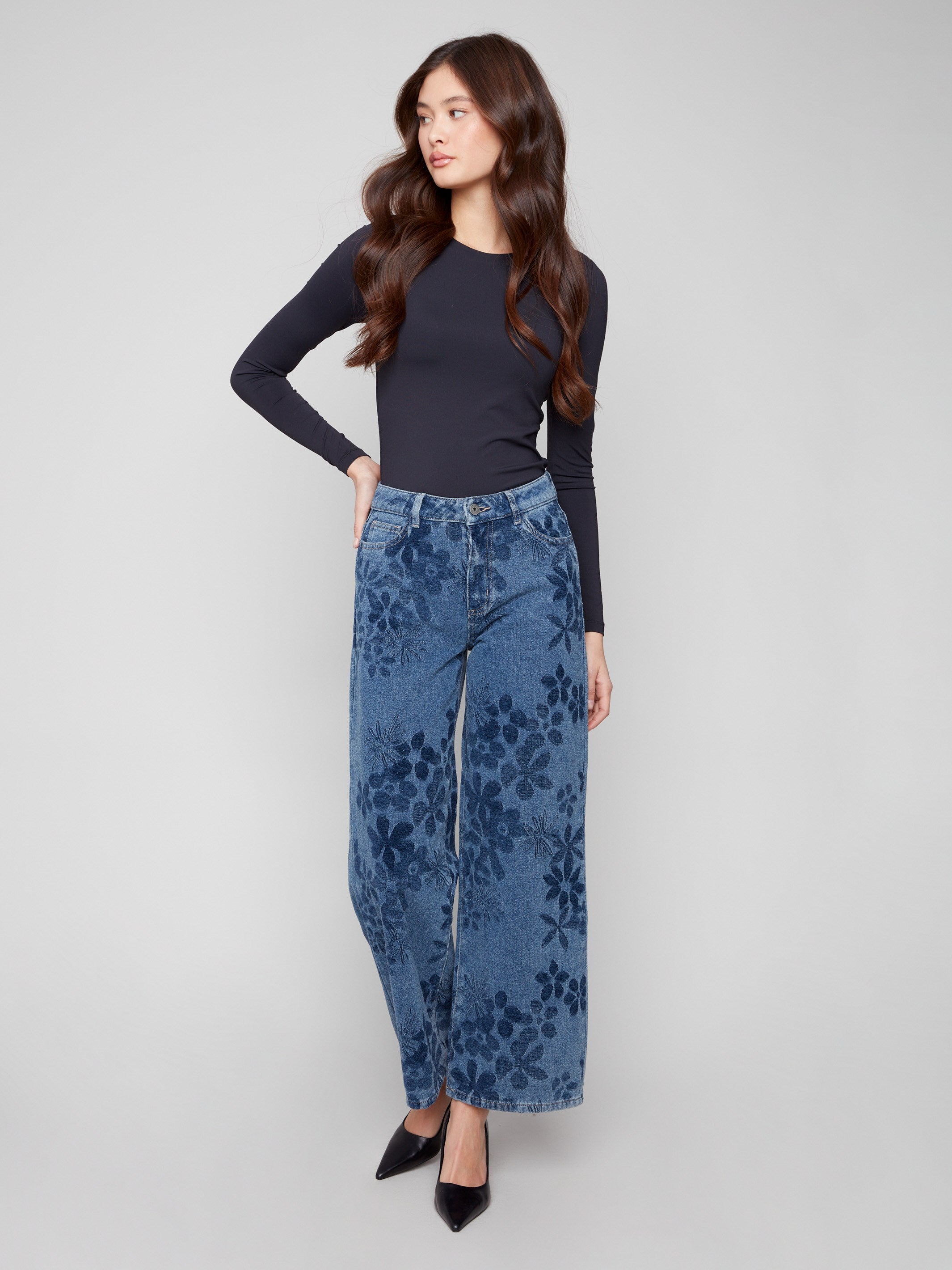 Featuring a five-pocket design, these blue jeans combine functionality and fashion with their floral patterns by Charlie B.