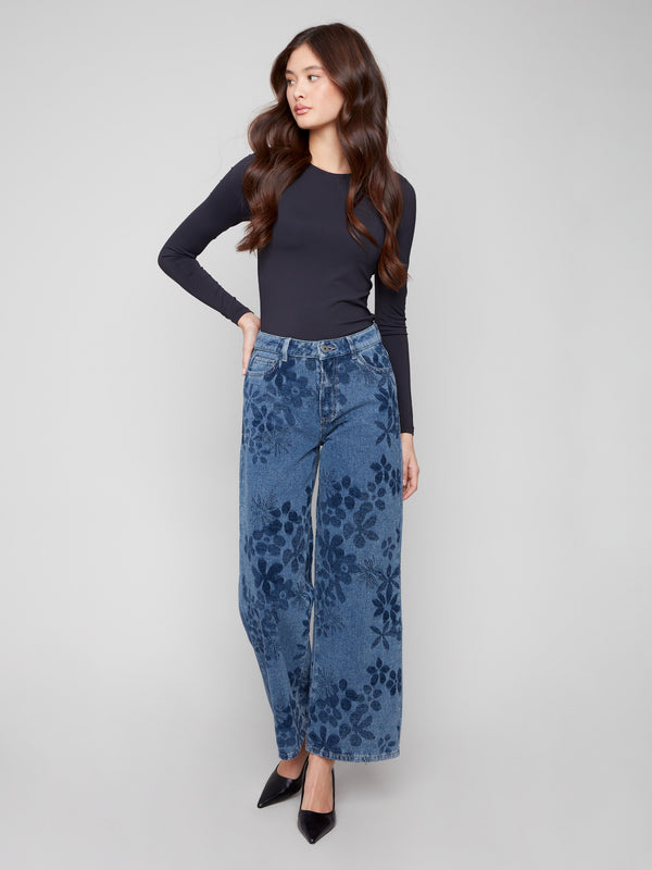 Featuring a five-pocket design, these blue jeans combine functionality and fashion with their floral patterns by Charlie B.