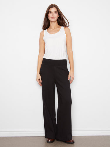Elegant black wide-leg French terry pants designed with functional zip side pockets and an elastic waistband by Charlie B.
