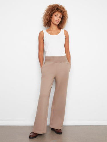 These pants have a regular rise, perfect for pairing with various tops for versatile looks. Styled by Charlie B.