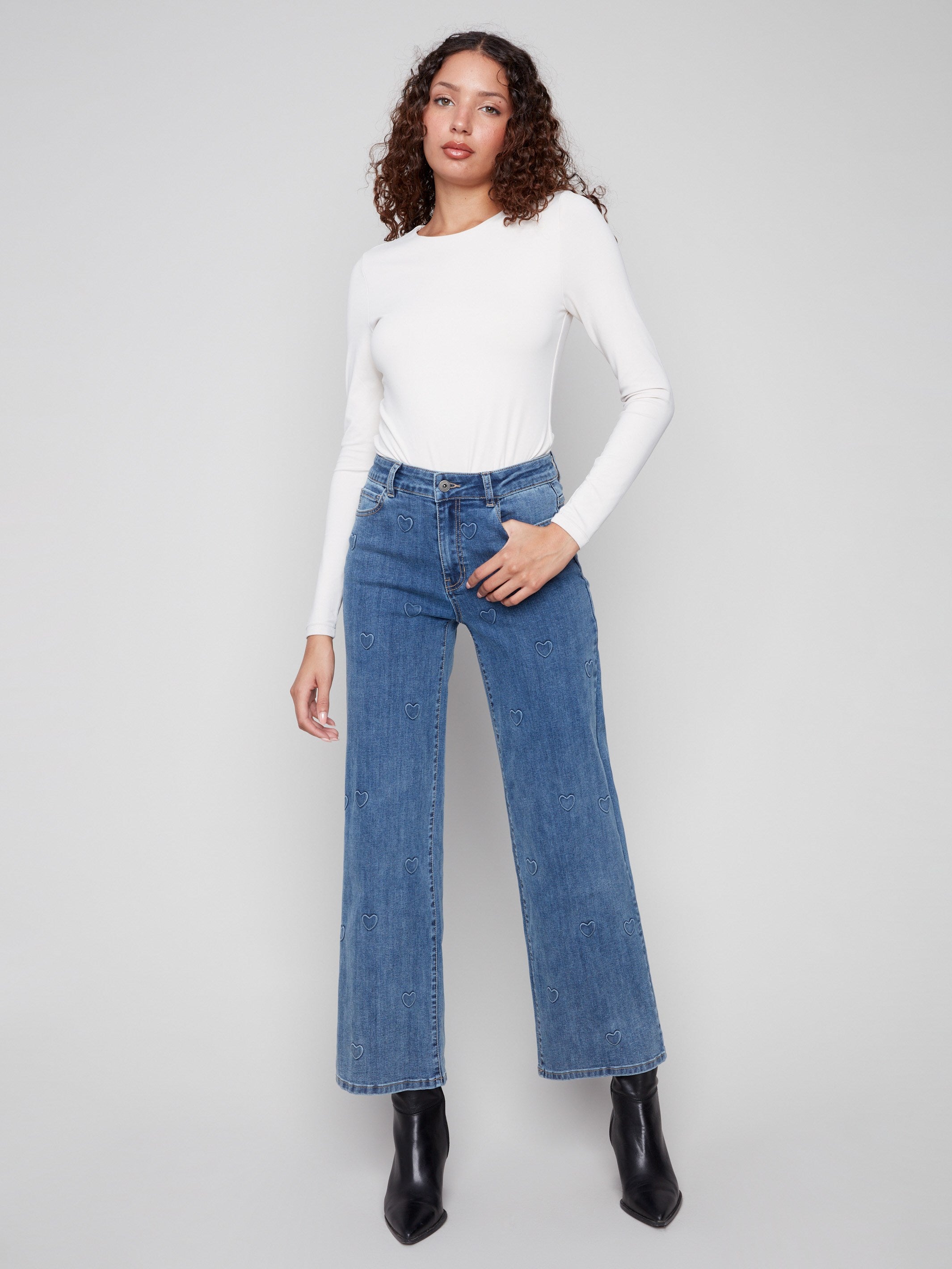 Blue jeans featuring a five-pocket design and heart pattern, offering both style and functionality by Charlie B.