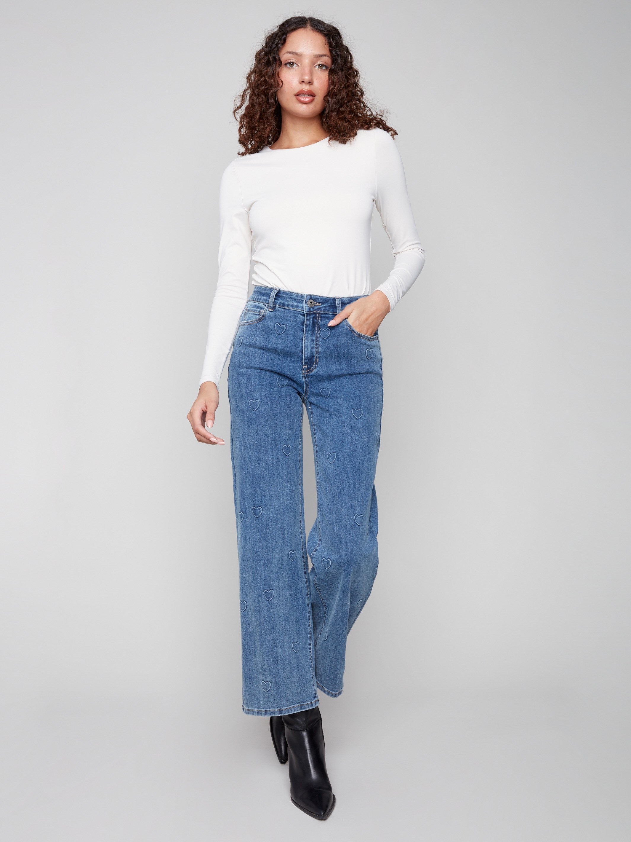 Regular rise blue jeans with an embossed heart pattern, combining elegance with everyday wearability by Charlie B.