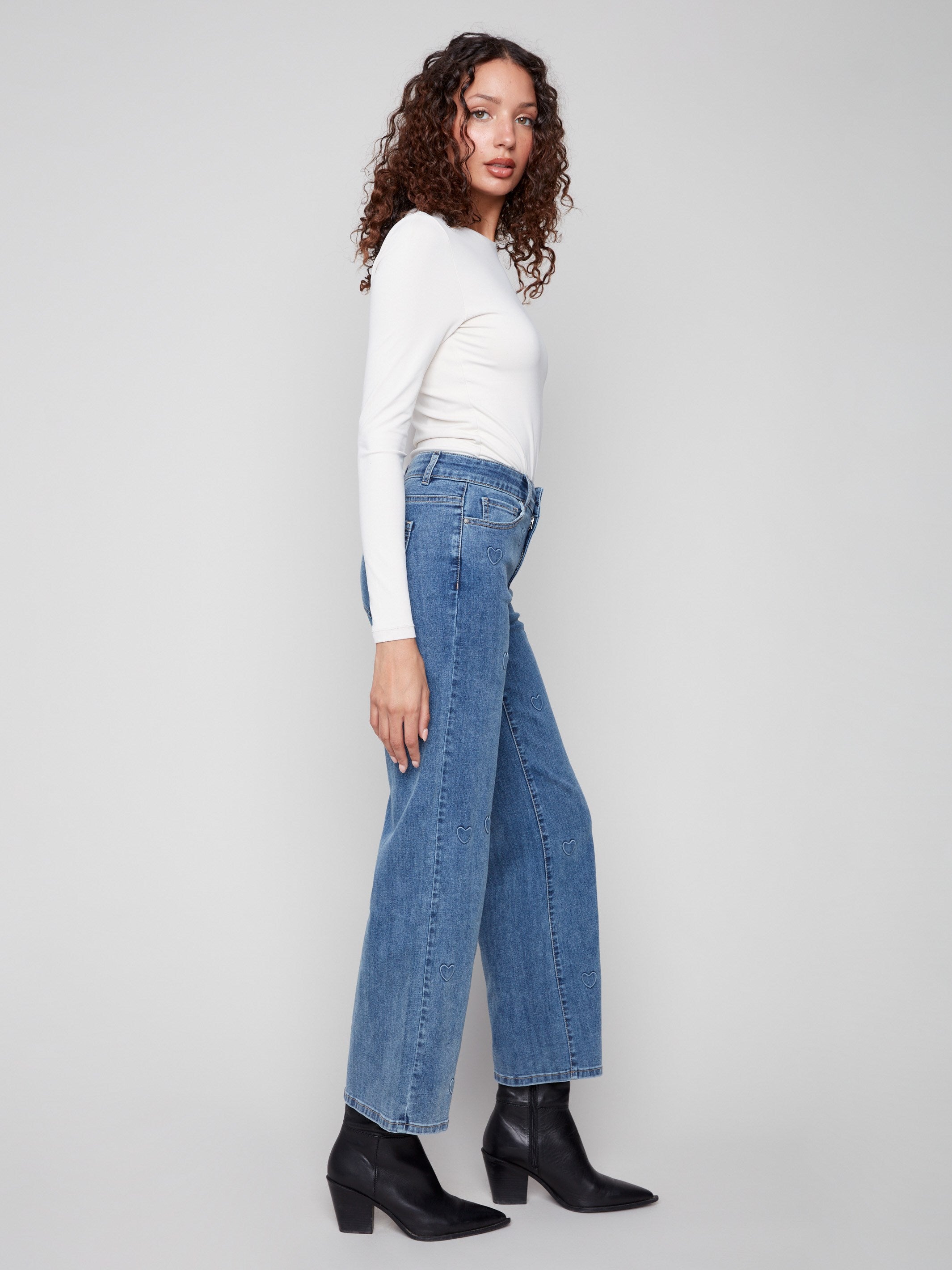 Long length wide-leg jeans in blue with charming heart details for a playful yet chic look by Charlie B.