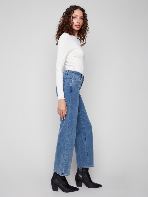 Long length wide-leg jeans in blue with charming heart details for a playful yet chic look by Charlie B.