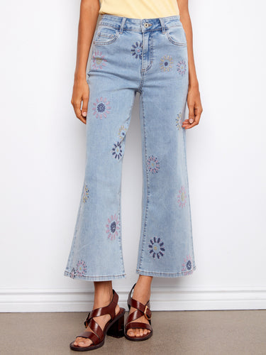 These jeans showcase a vibrant pixelated flower embroidery, crafted in stretch denim material with a five-pocket design by Charlie B.