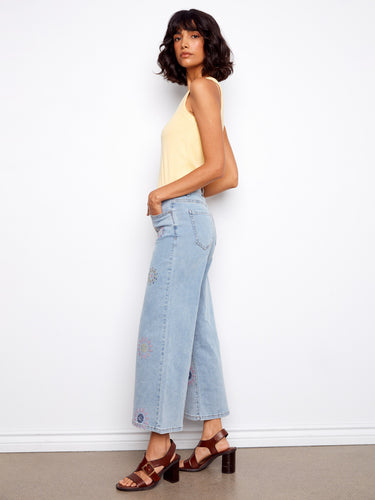 Stylish wide-leg jeans in stretch denim material, adorned with colorful pixelated flowers and offering a regular rise by Charlie B.