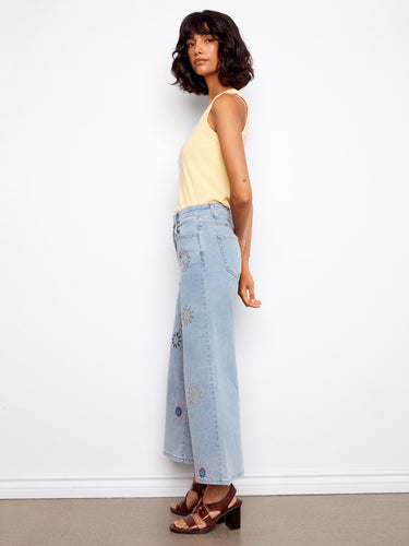Featuring five pockets and wide legs, these jeans have a playful pixelated flower design on durable stretch denim by Charlie B.