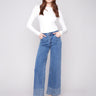 Medium blue jeans featuring a wide leg design with elegant patterned studs, crafted from stretch denim material by Charlie B.