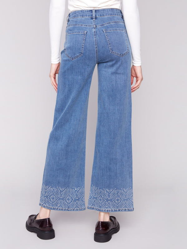 Crafted from stretch denim, these wide-leg jeans offer flexibility and style with unique studded hems by Charlie B.