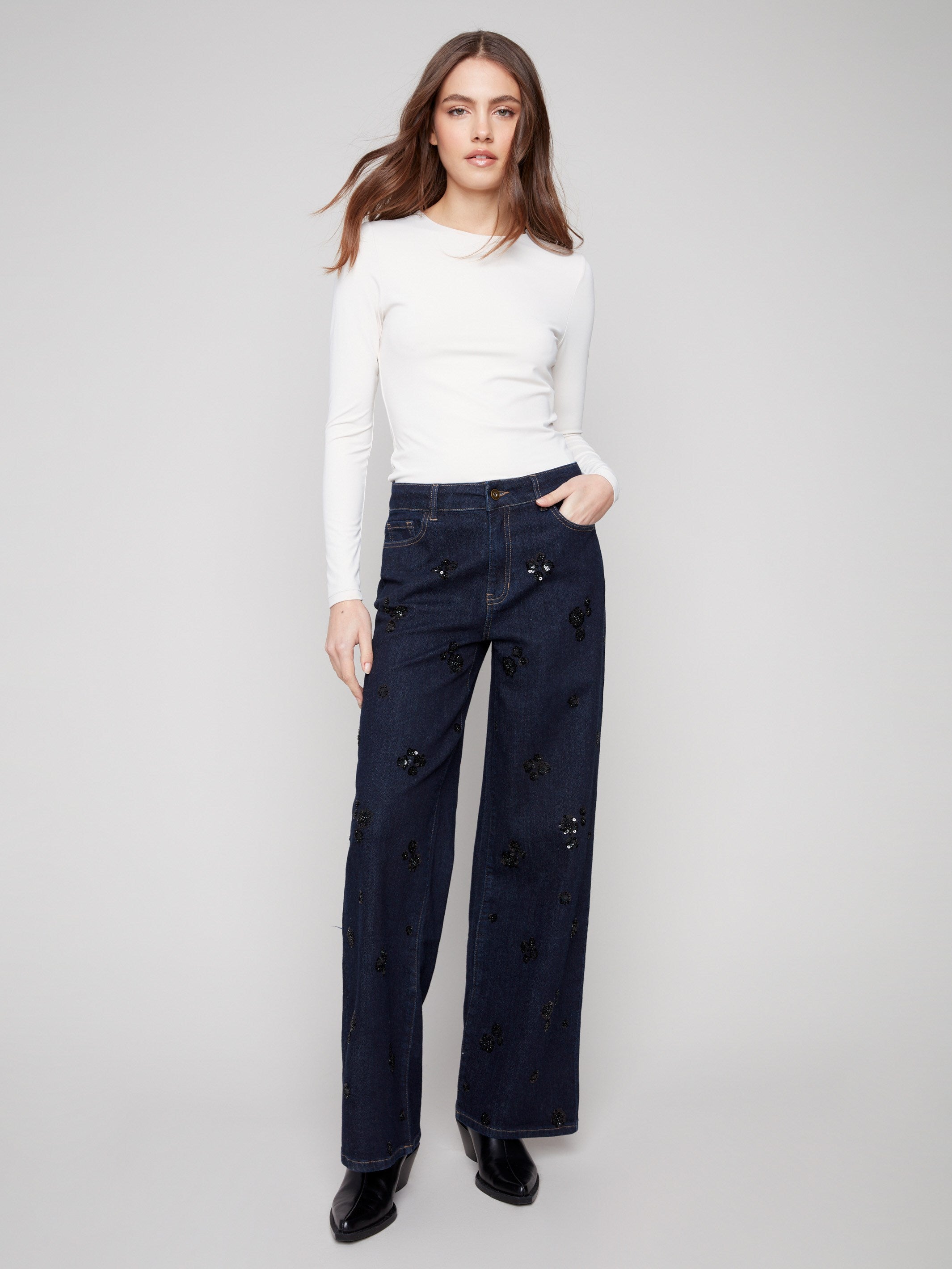 Denim jeans featuring a wide-leg cut and stretch fabric for comfort, adorned with sequins for added flair by Charlie B.