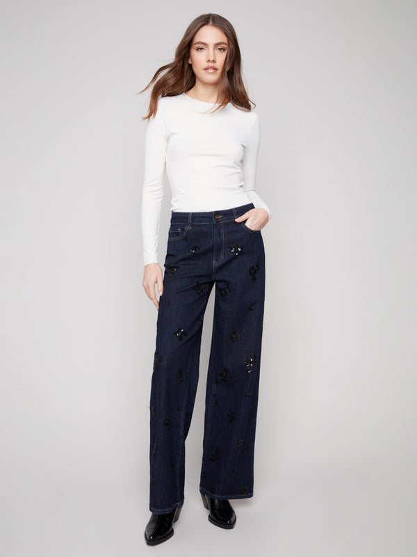 Denim jeans featuring a wide-leg cut and stretch fabric for comfort, adorned with sequins for added flair by Charlie B.