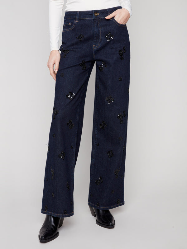 Long length denim trousers with intricate sequin floral embroidery, offering a touch of elegance by Charlie B.