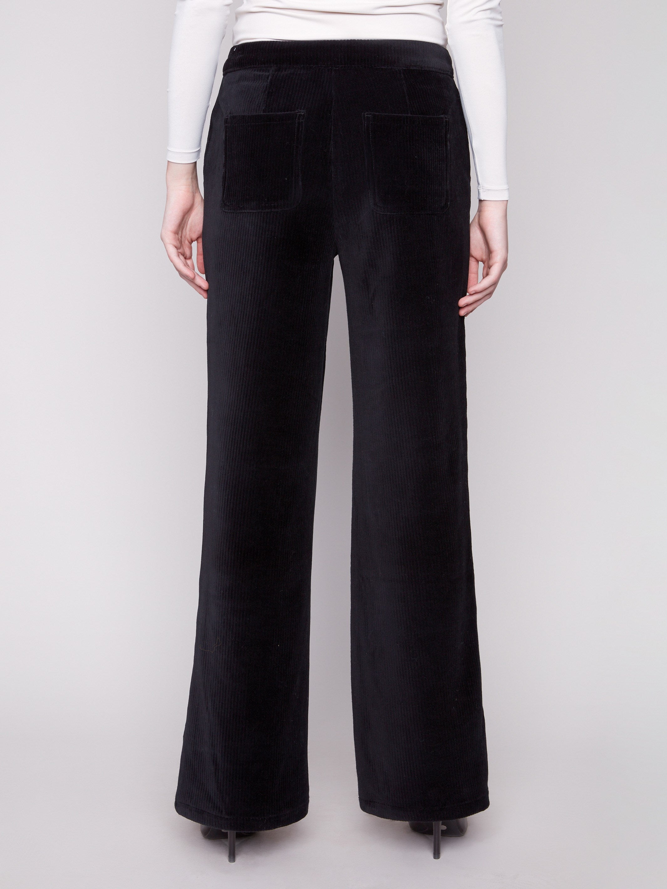 Black wide-leg pants designed with a sleek silhouette and long length for an elegant look by Charlie B.