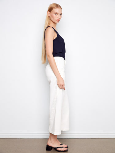 Elegant scalloped edges add a touch of sophistication to these stylish pants, ideal for any occasion. By Charlie B.