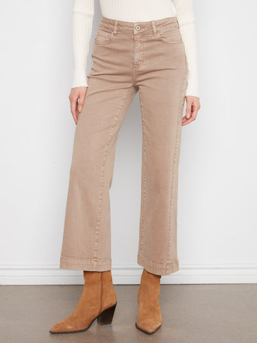 Twill pants in latte with ankle length, paired with a white top and brown boots. Features five-pocket design by Charlie B.