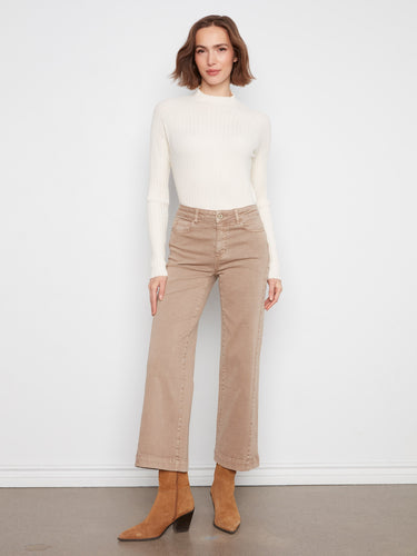 Ankle-length latte pants crafted from stretch twill fabric, matched with a white long-sleeve top and brown boots by Charlie B.