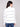 Stylish ecru sweater with funnel neck and classic black stripe pattern by Charlie B.