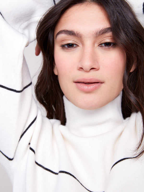 Elegant ecru knit with a relaxed fit and bold black stripes, crafted by Charlie B.